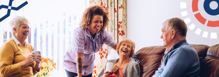 Nurse talking with three older adults, laughing