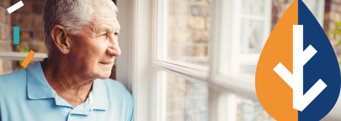 Older man looking out of window