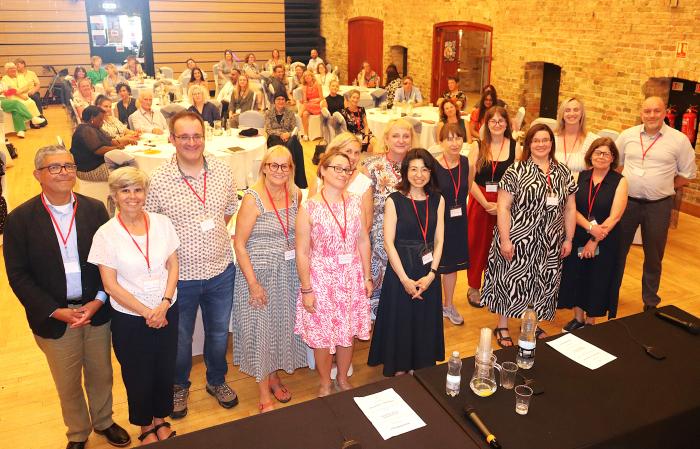 Group photo of NIHR ARC East of England research theme leads and workstream leads at the launch event in Ely, with attendees seated in the background